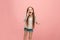 Isolated on pink young casual teen girl shouting at studio