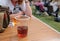 Isolated plastic pint beer and cider cups on a table, seen at a music festival.