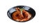 Isolated Pork rib chops steaks boiled with tomato sauce and cheese served in black round plate