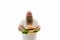 Isolated portrait of an overweigh man with tattooed arms looking happy and holding a big burger with sliced sausages and lettuce