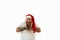 Isolated portrait on a white background of an overweigh man in Santa Claus hat looking at camera while touching his face and