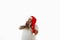 Isolated portrait on a white background of an overweigh man in Santa Claus hat touching his face expressing fear, or surprise.