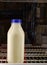 Isolated quart of white milk in vintage glass container in grocery store