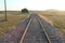 Isolated railway line with straight railway tracks leading into the distance