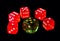 Isolated red and green transparent plastic playing dice with black background