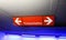 Isolated red neon sign giving direction to parking spaces for women german word: FrauenparkplÃ¤tze in underground car park