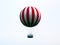 Isolated red and white adventure balloon. sphere shape with large viewing basket