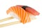 Isolated salmon and tuna nigiri on chopsticks and white background