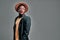 Isolated shot of fashionable serious young African American male in sunglasses, trendy hat and casual jacket , looks aside,