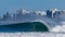 Isolated shot of a foaming sea wave in the background of a resort buildings