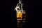 Isolated shot of whiskey with splash on black background, brandy in a glass