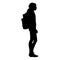 Isolated silhouette of a schoolgirl standing with a backpack