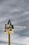 Isolated snowy-covered birdhouse close up with cold winter sky on background