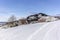 Isolated summer chalet and farm stables high up on the Swiss Alps covered in fresh powder snow near Bruelisau in Appenzell