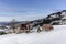 Isolated summer chalet and farm stables high up on the Swiss Alps covered in fresh powder snow near Bruelisau in Appenzell