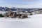 Isolated summer chalet and farm stables high up on the Swiss Alps covered in fresh powder snow near Bruelisau in Appenzell