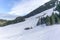 Isolated summer chalet and farm stables high up on the Swiss Alps covered in fresh powder snow near Bruelisau in Appenzell and