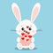 Isolated sweet and cute white rabbit in sitting pose with flying red hearts from an open pink envelope