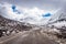 Isolated tarmac road with snow cap mountain background and amazing sky at morning