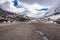 Isolated tarmac road with snow cap mountain background and amazing sky at morning