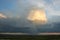 Isolated thundery shower with rain shaft at sunset