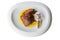 Isolated top view of pan seared trout. served with yellow sauce, foam and roasted sliced onion on curved white plate