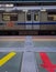 Isolated train standing at vacant metro station at day from flat angle