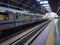 Isolated train standing at vacant metro station at day from flat angle