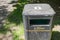 Isolated view of a British style litter bin showing its rectangular design.