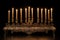 an isolated view of a bronze menorah with flickering light from the candles