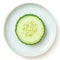 Isolated view of single cucumber slice on white background, plate