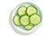 Isolated view of single cucumber slice on white background, plate