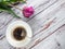 Isolated violet tulip and cup of coffee with free space for text or label