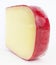 Isolated wedge of Dutch red wax gouda cheese