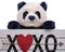 Isolated on white background stuffed plush Panda Bear toy is holding a Heart XOXO hugs and kisses wooden sign.