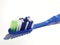 Isolated white photo of a plastic toothbrush that has been used several times. This toothbrush has a blue handle