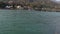 Isolated young indian girl sitting at ganges river bank from flat angle