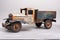 isolateded old tin cargo truck toy from the year 1950 faded profile