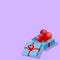 Isometric 3d hearts in a blue gift box, a lovely present for valentine`s day theme on purple background.