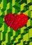 Isometric cube block in heart shape on green BG