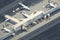 isometric view of busy airport terminal, with airplanes taking off and landing