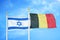 Israel and Belgium two flags on flagpoles and blue cloudy sky