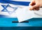 israel elections hand putting vote in ballot