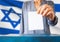 israel elections hand putting vote in ballot