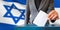 israel elections hand putting vote in ballot