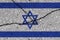 Israel flag on cracked concrete wall. The concept of crisis, default, economic collapse, pandemic, conflict, terrorism