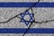 Israel flag on cracked concrete wall. The concept of crisis, default, economic collapse, pandemic, conflict, terrorism