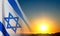 Israel flag with a star of David against the sunset. Patriotic concept