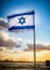 Israel flag waving cloudy sky background sunset