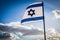 Israel flag waving cloudy sky background sunset